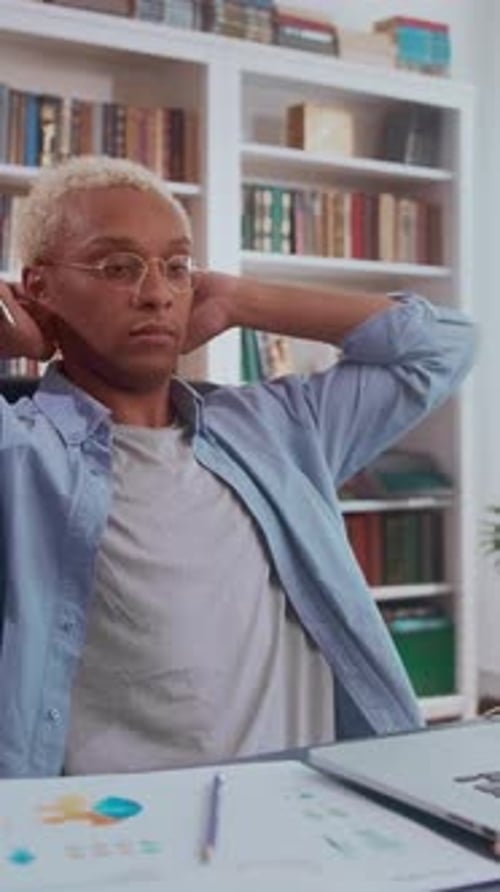 Young African American Man Working Diligently at a Laptop in Cozy Room
