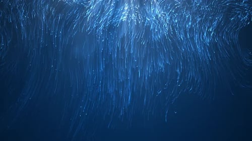 Flüssige Weihnachtspartikel auf blauem Hintergrund