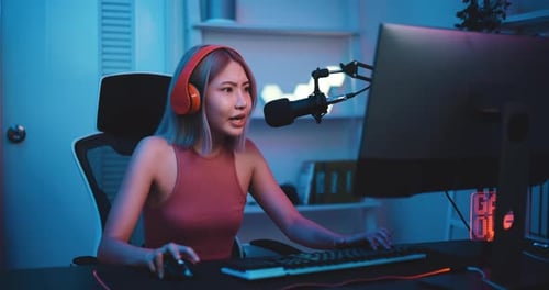 Young Adult Plays Video Game in Blue Room