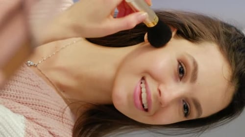 Woman Applies Makeup with Brush, Close Up