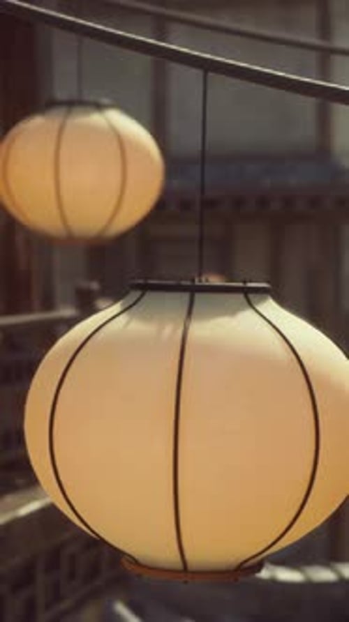 A Group of Lanterns Hanging From a Line