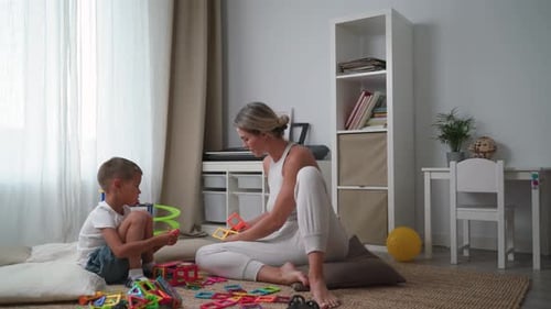 Mother and Son Building with Magnetic Blocks at Home