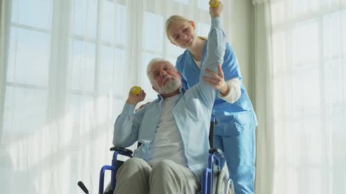 Senior Man Exercising with Nurse's Help