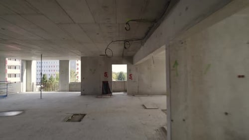 Moving shot through the window of the building under construction.