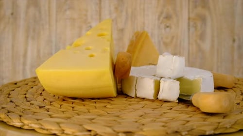 Assorted Cheeses Displayed on Woven Mat