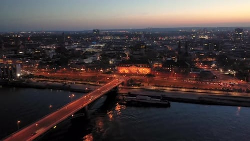 Leaving Mainz by night with a drone at magic hour over the Rhine river and the old bridge