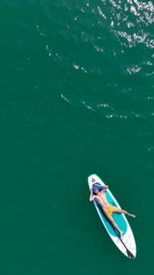 Vertical Video Scenic Paddleboarding Adventure Through a Canyon With Friends on a Sporty Trip