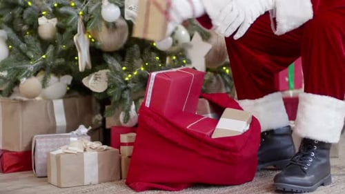Santa Arranges Gifts Under Christmas Tree