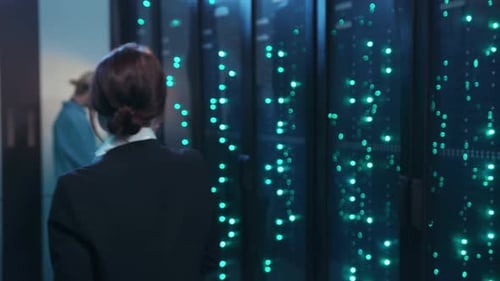 A Team in a Server Room Works Efficiently on Tech Operations