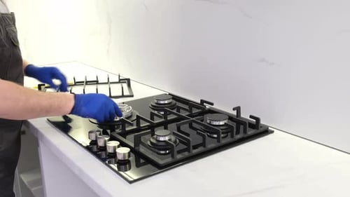 Man Installs Glass Cooktop in Modern Kitchen