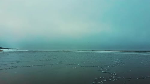 Aerial Shot Sea Smoke in Winter. Fog and Steam in the Baltic Sea Ice and Steam Rises Over Sea Bay