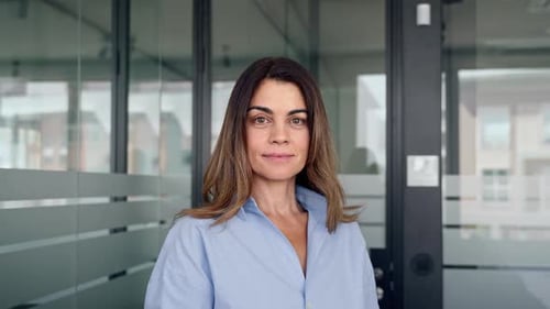 Smiling Middle Aged Business Woman Leader Crossing Arms in Office Portrait