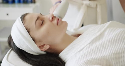 A Cosmetologist Therapist Gives a Rejuvenating Facial Massage