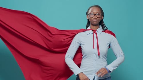 African American Woman Posing As Superhero with Red Flying Cape