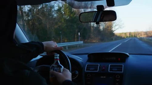 Closeup of Hand Opening Drink While Driving on Highway, Risky Action