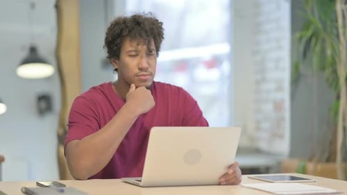 Man Typing on Laptop at Office Desk