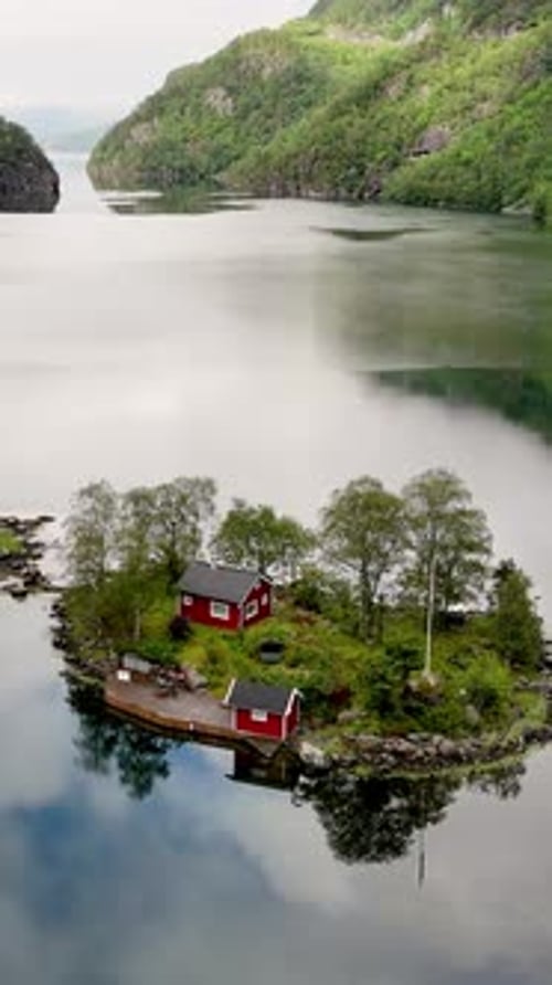 Majestic Norway Fjord with Charming Red Cabin Surrounded By Serene Waters