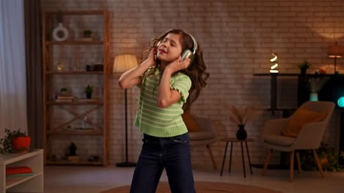 Girl Dancing to Music in Living Room
