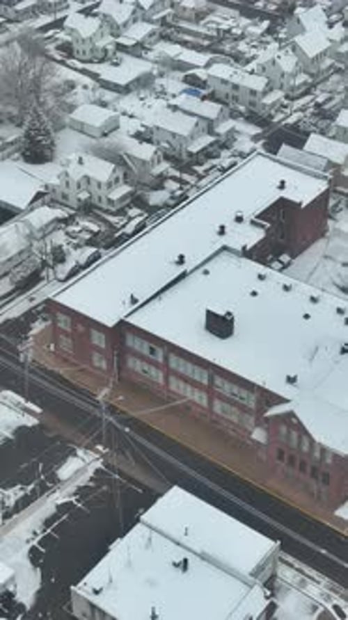 Snowfall Aftermath Aerial View of Small Town with Snow Covered Roofs