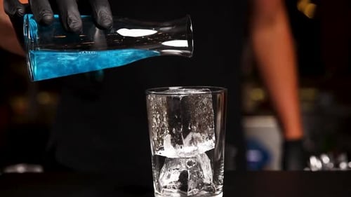 the bartender prepares a cocktail at the bar