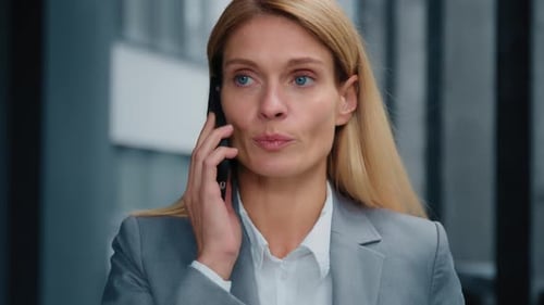 Businesswoman Talking on Phone in Corporate Setting