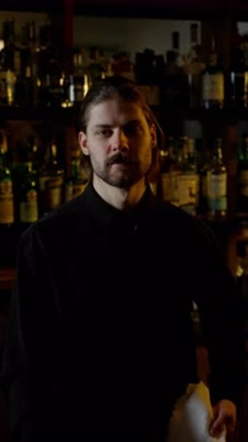 Stern Bartender Behind Bar Counter