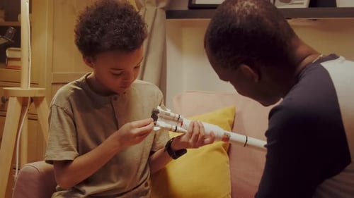 Father And Son Building Toy Rocket