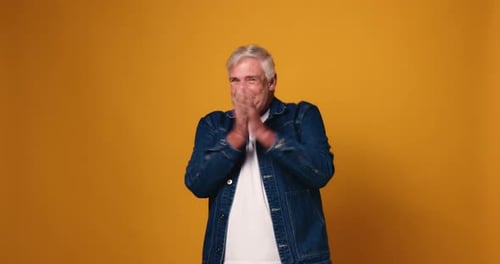 Face, mature man and celebration in studio for lottery winner, game show bonus or cheering