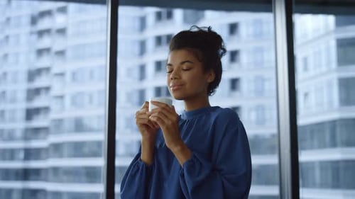 Smiling Business Woman Drinking Coffee Cup in Office Lobby. Portrait African Businesswoman