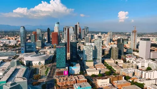 Flying closer to a group of modern skyscrapers in the downtown of Los Angeles, California, USA