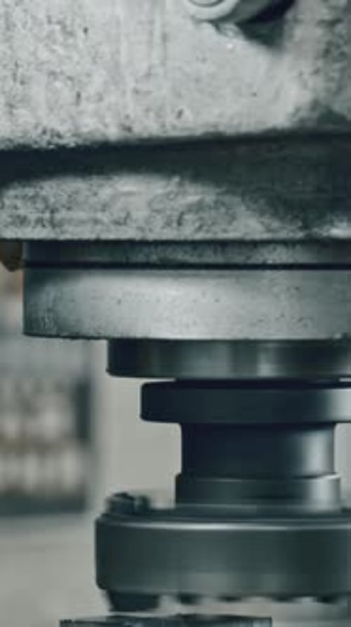 Metalworking process in factory with sparks flying from industrial machine press