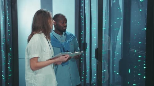 Technicians Inspecting Data Servers in Data Center