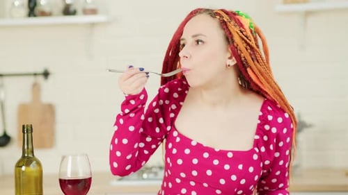 Woman Eating Salad in a Kitchen