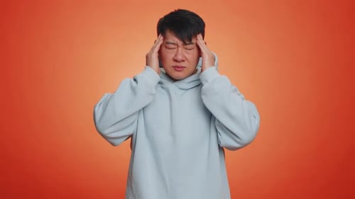 Young Adult with Headache Gesturing