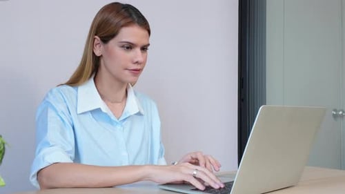 Happiness young businesswoman using laptop computer on desk in living room at home office.