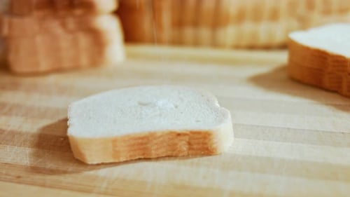 Salt Being Sprinkled on Slice of White Bread