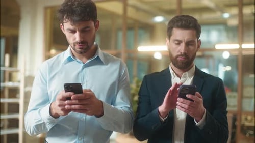 Businessmen Using Smartphones in Modern Office Environment