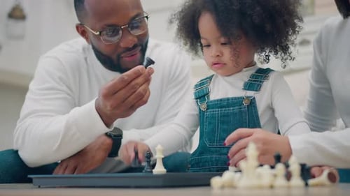 Family Plays Chess Together at Home