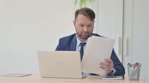 Frustrated Man Working in Office Reacts to Bad News