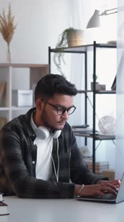 Man Working on Laptop in Home Office