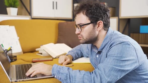 Man Using Laptop While Lying on Sofa