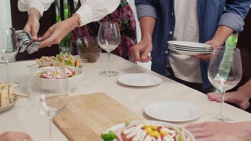 Friends Setting Table for Lunch Together Indoors