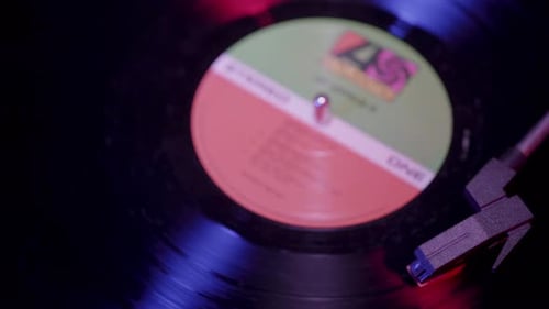 Top view of Vinyl Record player Spinning with cinematic red and blue lighting
