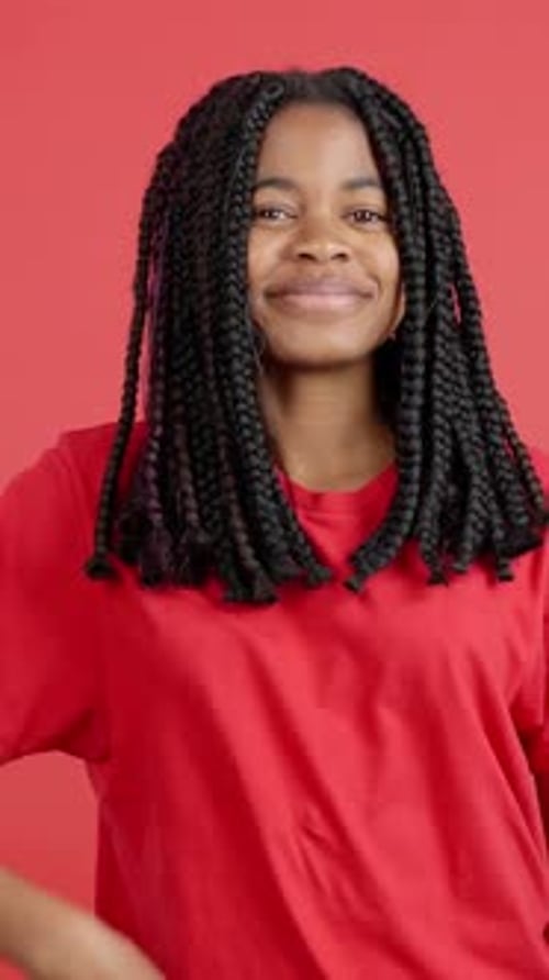 Teenage Girl Giving Thumbs Up on Red Background