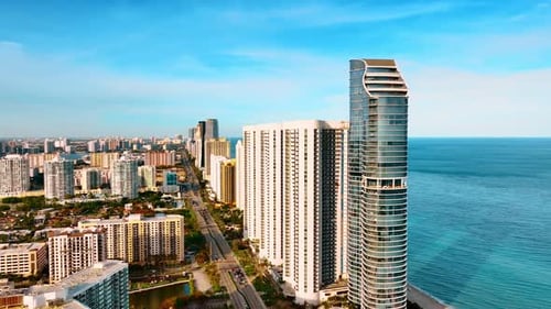 Approaching high-rise architecture on the shore of the Atlantic Ocean.