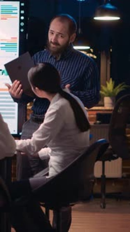 Professionals Reviewing Charts and Data in Modern Office