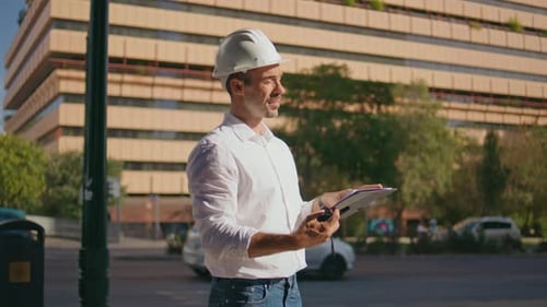 Focused Engineer Checking Building Plan at Sunbeams City Closeup Man Working