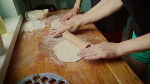 Two People Preparing Dough in Kitchen