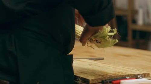 Chefs preparing fresh vegetables in commercial kitchen
