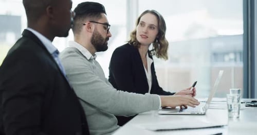 4k video footage of a group of businesspeople working together on a laptop in an office